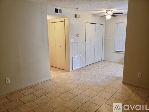 A room with a tile floor and a ceiling fan.