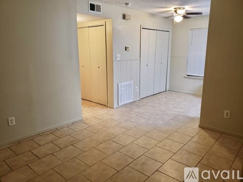 A room with tile flooring and a ceiling fan.