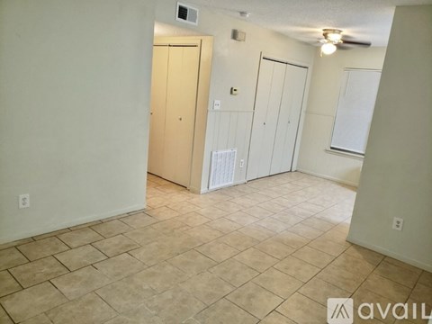 A room with tiled flooring and a wall-mounted air conditioning unit.