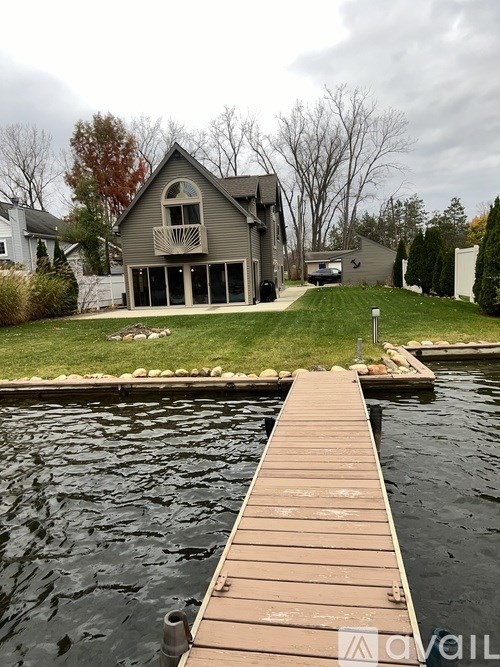 A house with a deck overlooking a body of water.