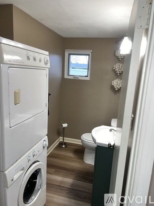 A small bathroom with a washer and dryer built in.