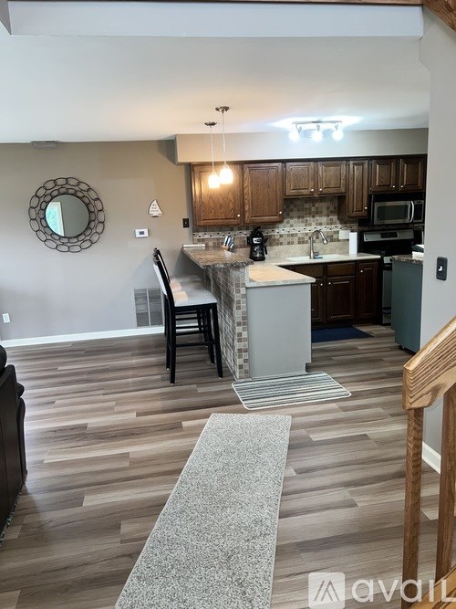 A kitchen with wooden cabinets and a white island.