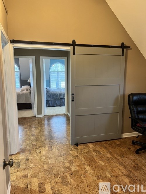 A room with a sliding door and a chair.