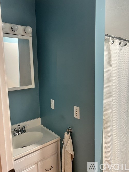 A white sink in a blue bathroom.