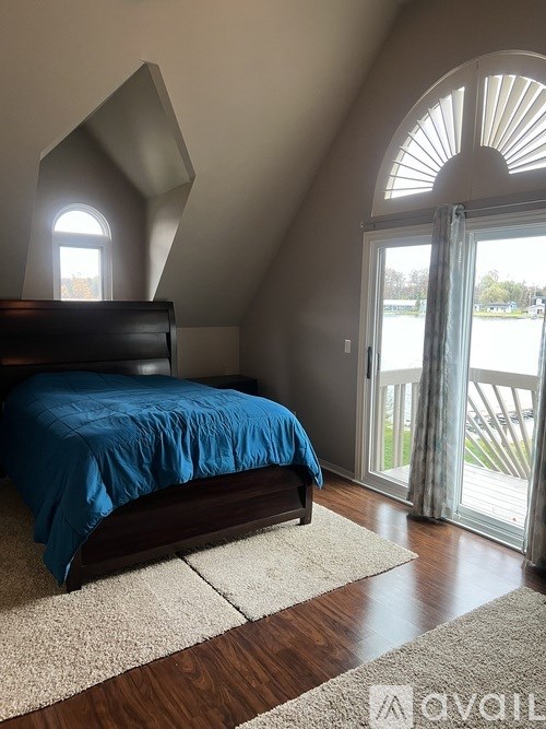 A bedroom with a bed and a window.