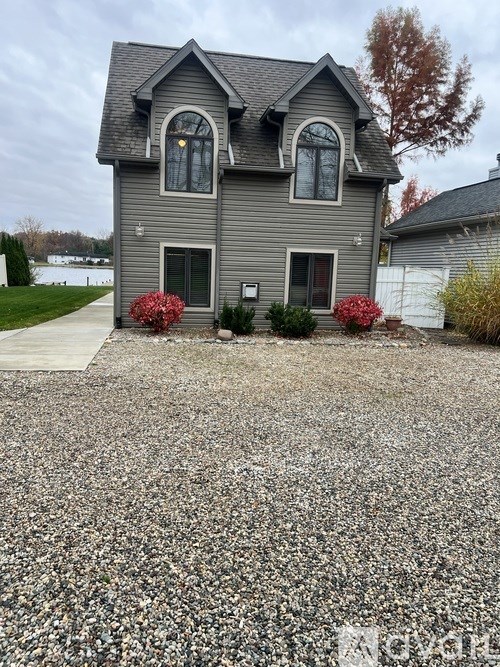 A grey house with a grey roof and a grey front door.