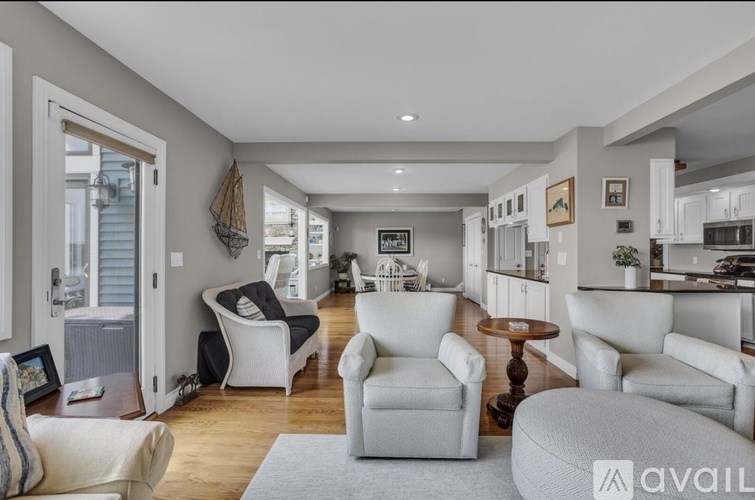 A living room with a grey sofa and a white chair.