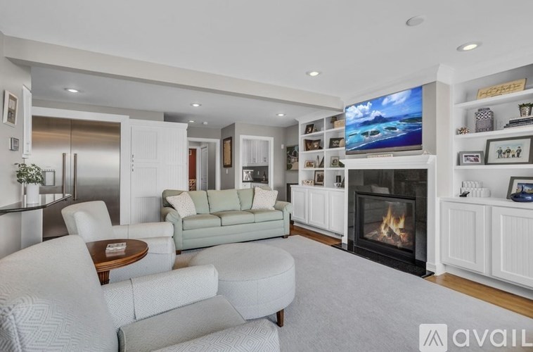 A modern living room with a fireplace and a television.