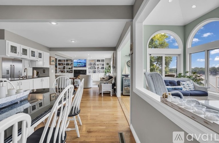 A modern kitchen with white cabinets and a large island.