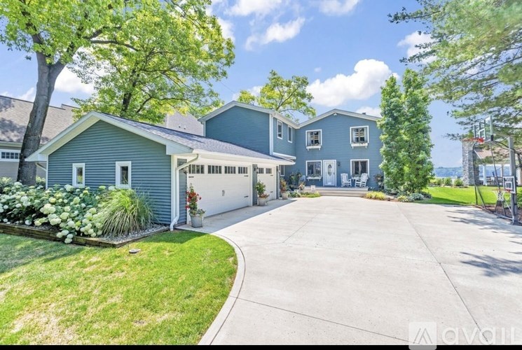 A large house with a driveway in front of it.