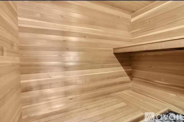 A wooden sauna with a bench at the bottom.