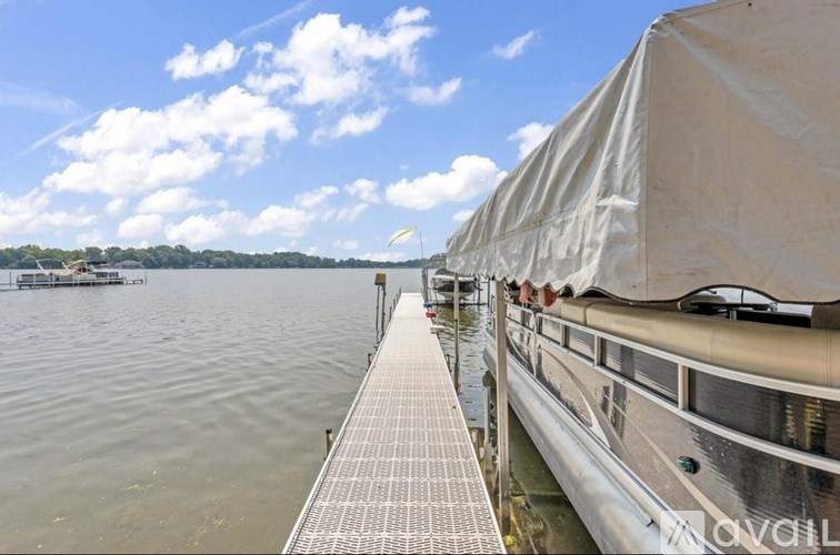 A boat is docked at a pier on a sunny day.