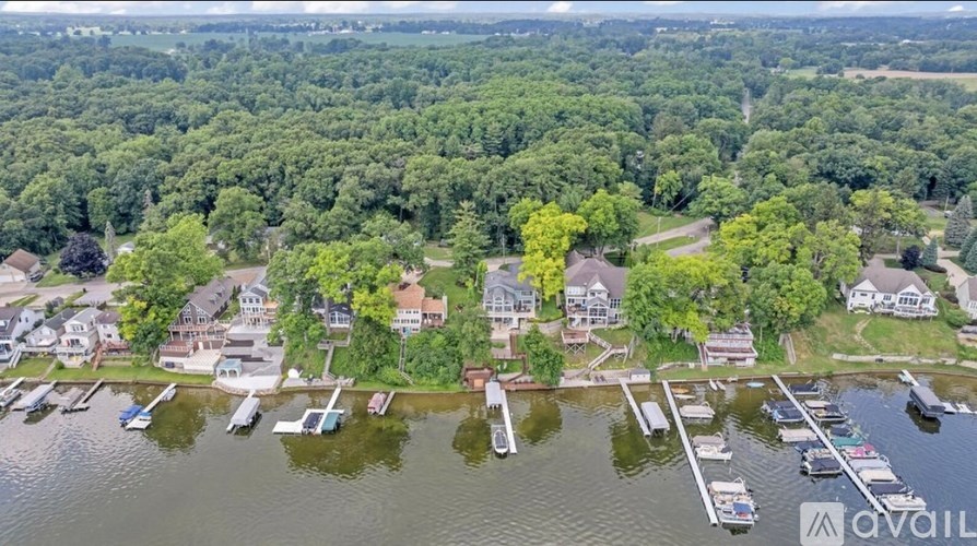 A bird's eye view of a marina with boats docked in the water.