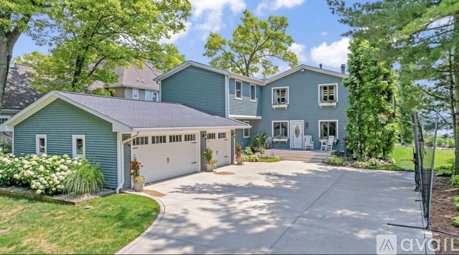 A large house with a driveway in front of it.