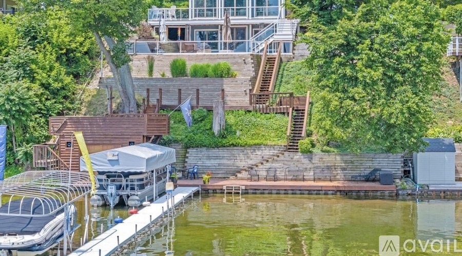 A dock with a boat and a building in the background.