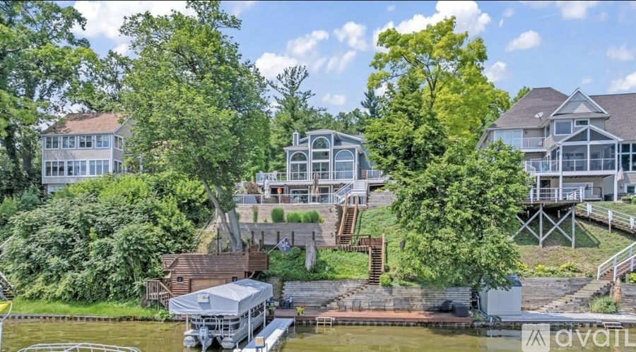 A house with a boat in front of it is for sale.