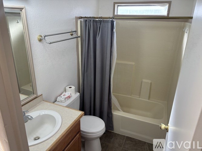 A bathroom with a toilet, sink, and shower.