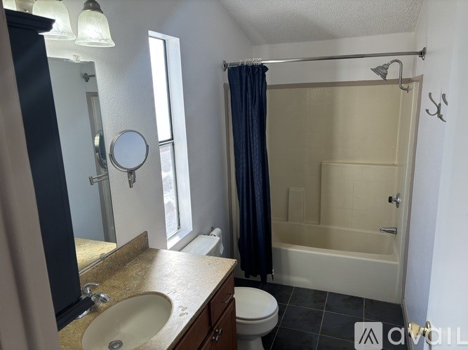 A bathroom with a sink, toilet, and bathtub.