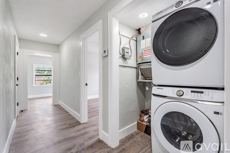 A laundry room with a washer and dryer stacked on top of each other.