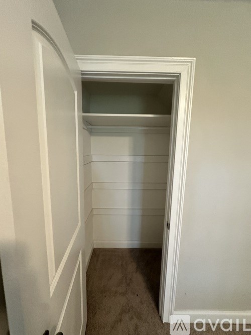 A small, empty room with a doorway leading to another room.