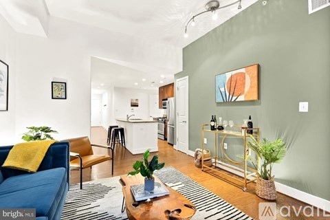 A living room with a blue couch and a wooden coffee table.