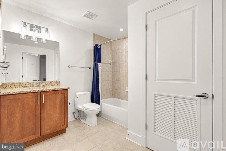 A bathroom with a toilet, sink, and bathtub.