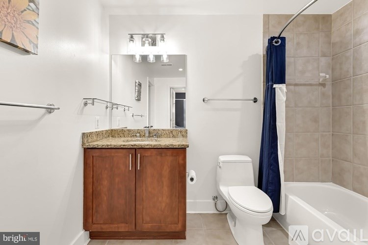 A bathroom with a toilet, sink, and shower.
