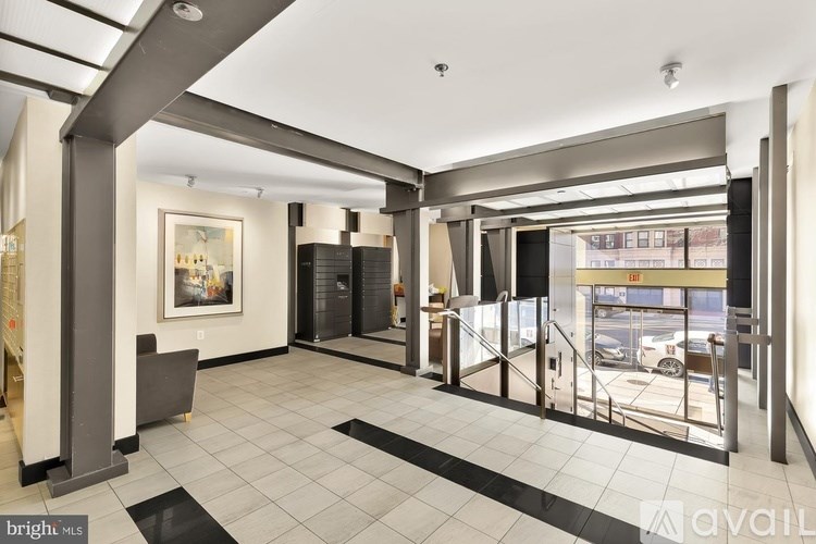 A bright and modern hallway with a glass door leading to a parking lot.