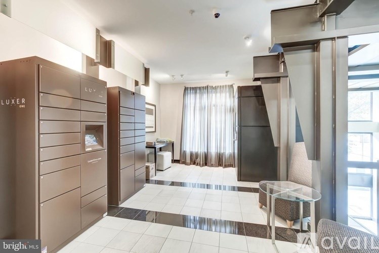 A modern living room with a glass table and a chair.
