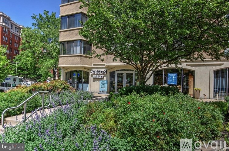 A building with a sign that says "Streets Markets" in front of it.