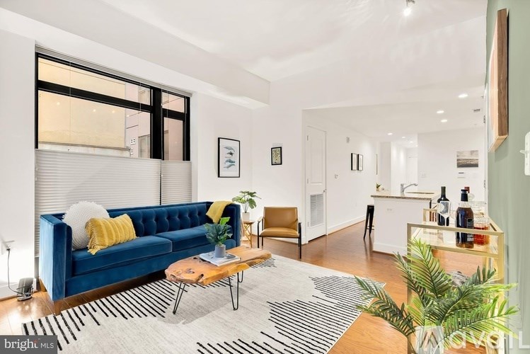 A living room with a blue couch and a coffee table.