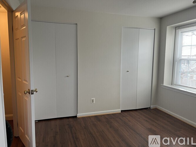A room with two closets and a door.