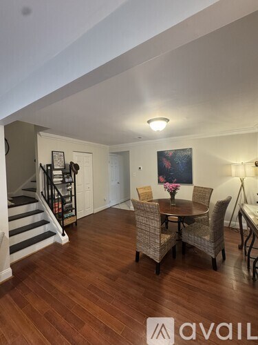 A living room with a dining table and chairs.