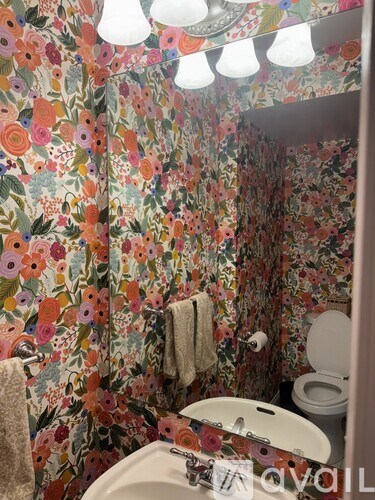 A floral patterned shower curtain in a bathroom.