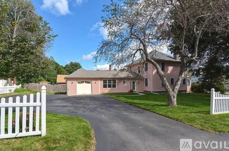 A house with a white picket fence in front.