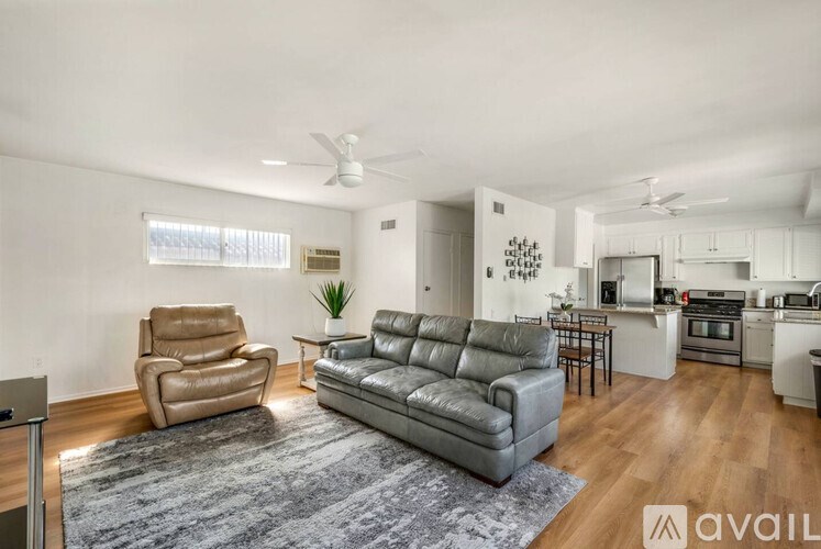 A living room with a grey couch and a grey chair.
