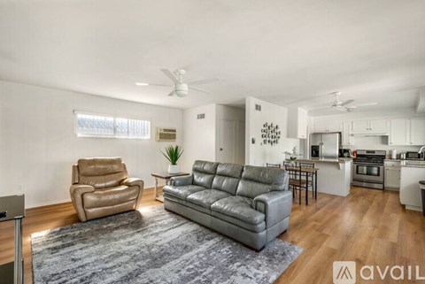A living room with a grey couch and a grey chair.