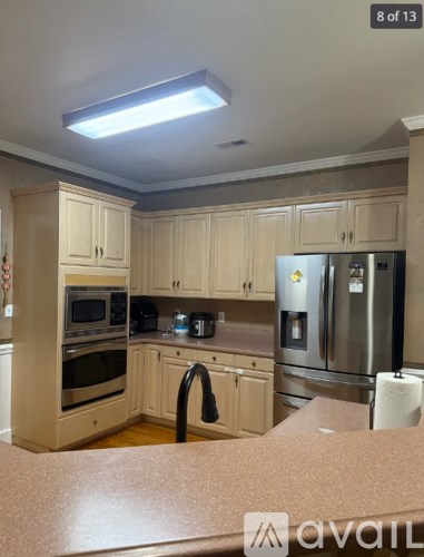 A kitchen with wooden cabinets and stainless steel appliances.