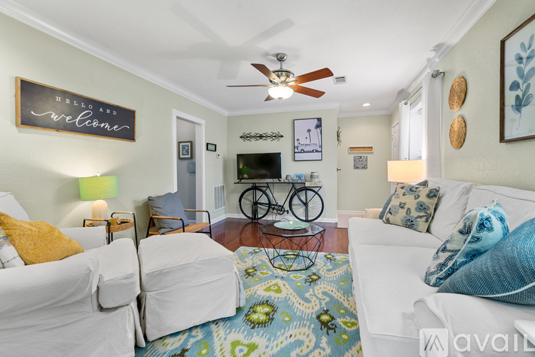 A living room with a bicycle on the wall and a rug on the floor.