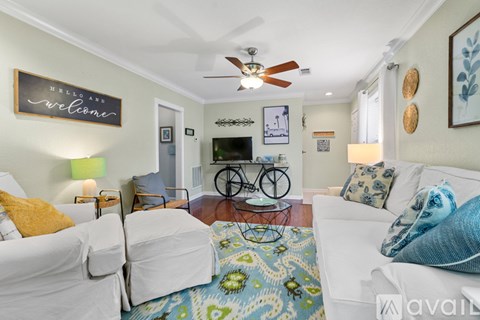 A living room with a bicycle on the wall and a rug on the floor.
