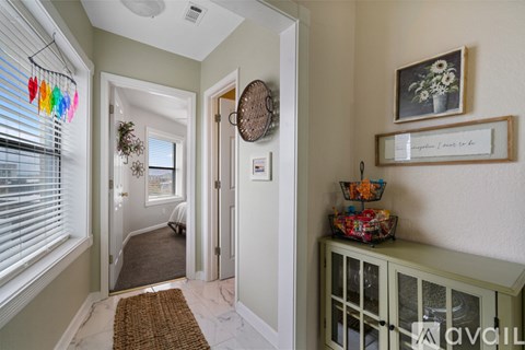 A hallway with a basket of fruit on a cabinet.