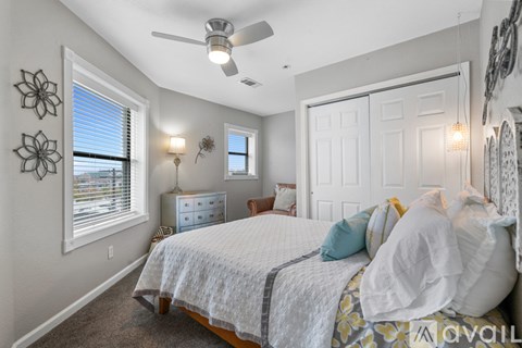 A bedroom with a bed, dresser, and window.