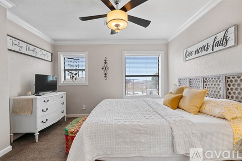 A bedroom with a bed, dresser, and window.