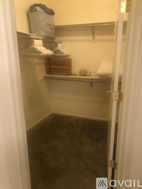 A small, dark room with a shelf and a door.