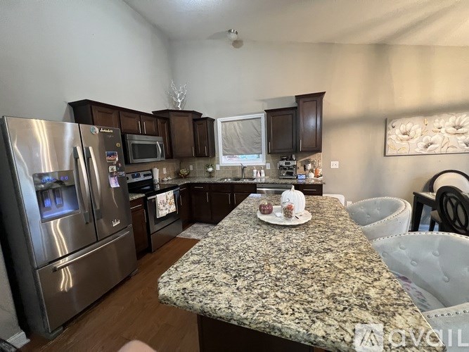 A kitchen with granite countertops and stainless steel appliances.