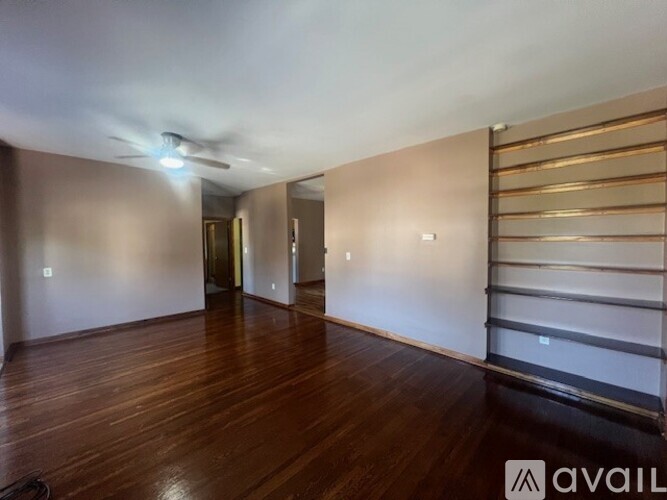 A room with wooden floors and a sliding door.