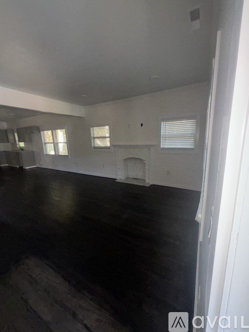 A room with a fireplace and a window.