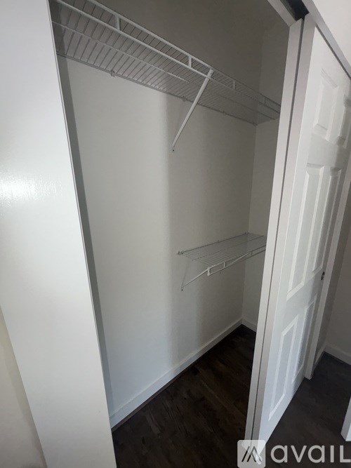 Empty white refrigerator with a white door.