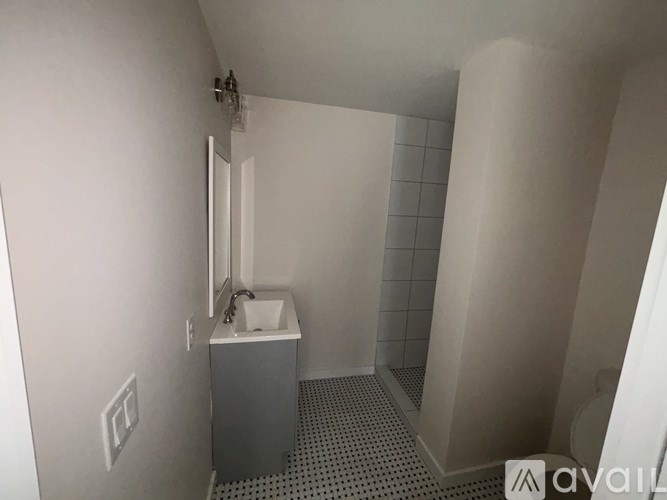 A small white sink in a small bathroom.