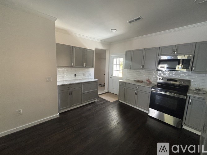 A kitchen with a stove top oven and a microwave.